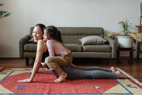 Mum And Daughter On An Area Rug